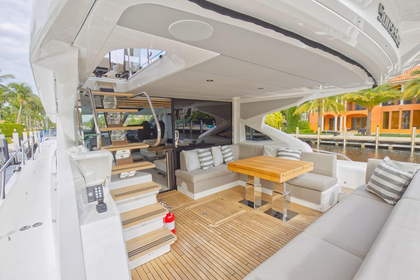 a room with a couch and a table and a bench aboard SUNSEEKER 75 SPORT YACHT Yacht for Sale