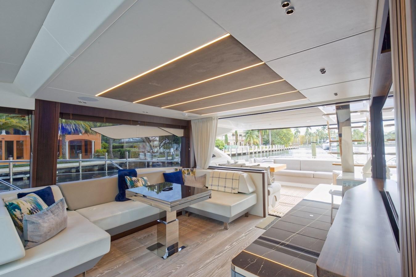 a room with a table and couches aboard SUNSEEKER 75 SPORT YACHT Yacht for Sale