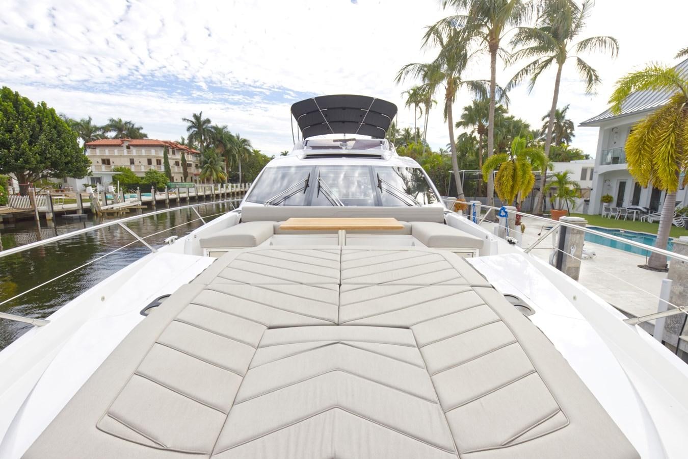 a white car with a roof and a white roof with a white awning and palm trees and aboard SUNSEEKER 75 SPORT YACHT Yacht for Sale
