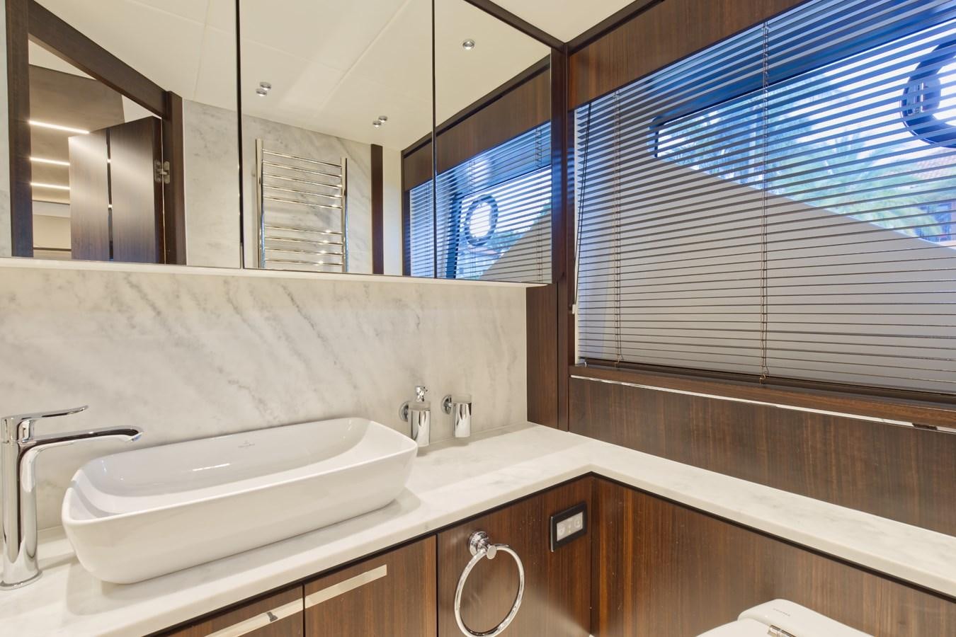 a bathroom with a sink and a mirror aboard SUNSEEKER 75 SPORT YACHT Yacht for Sale