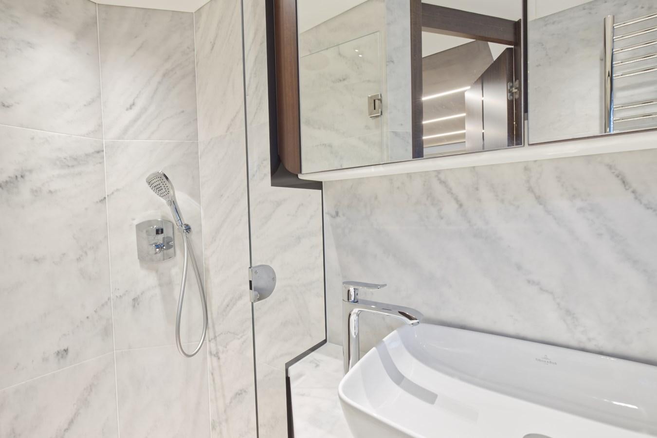 a bathroom with a sink and a mirror aboard SUNSEEKER 75 SPORT YACHT Yacht for Sale