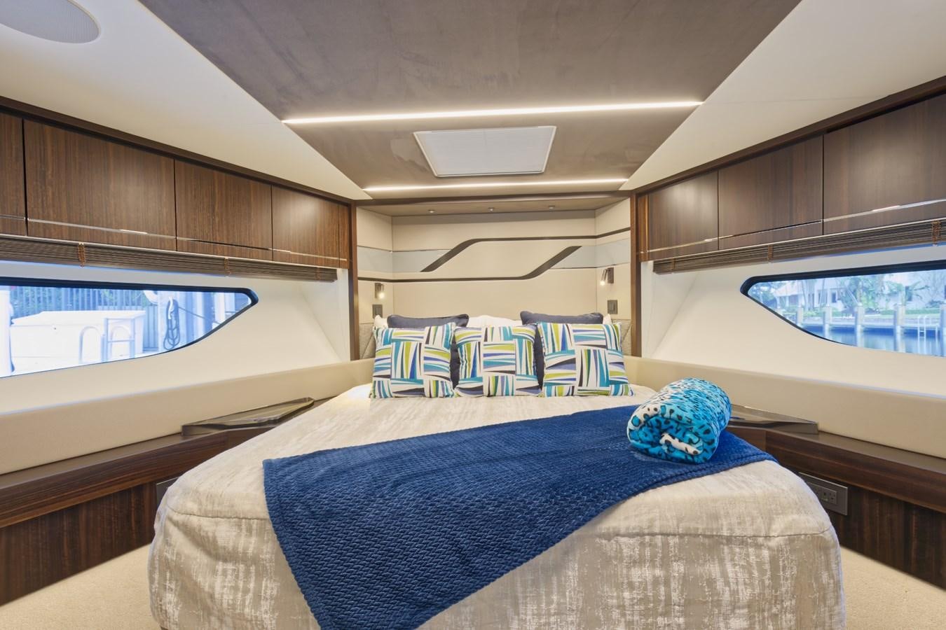 a bedroom with a blue bed aboard SUNSEEKER 75 SPORT YACHT Yacht for Sale