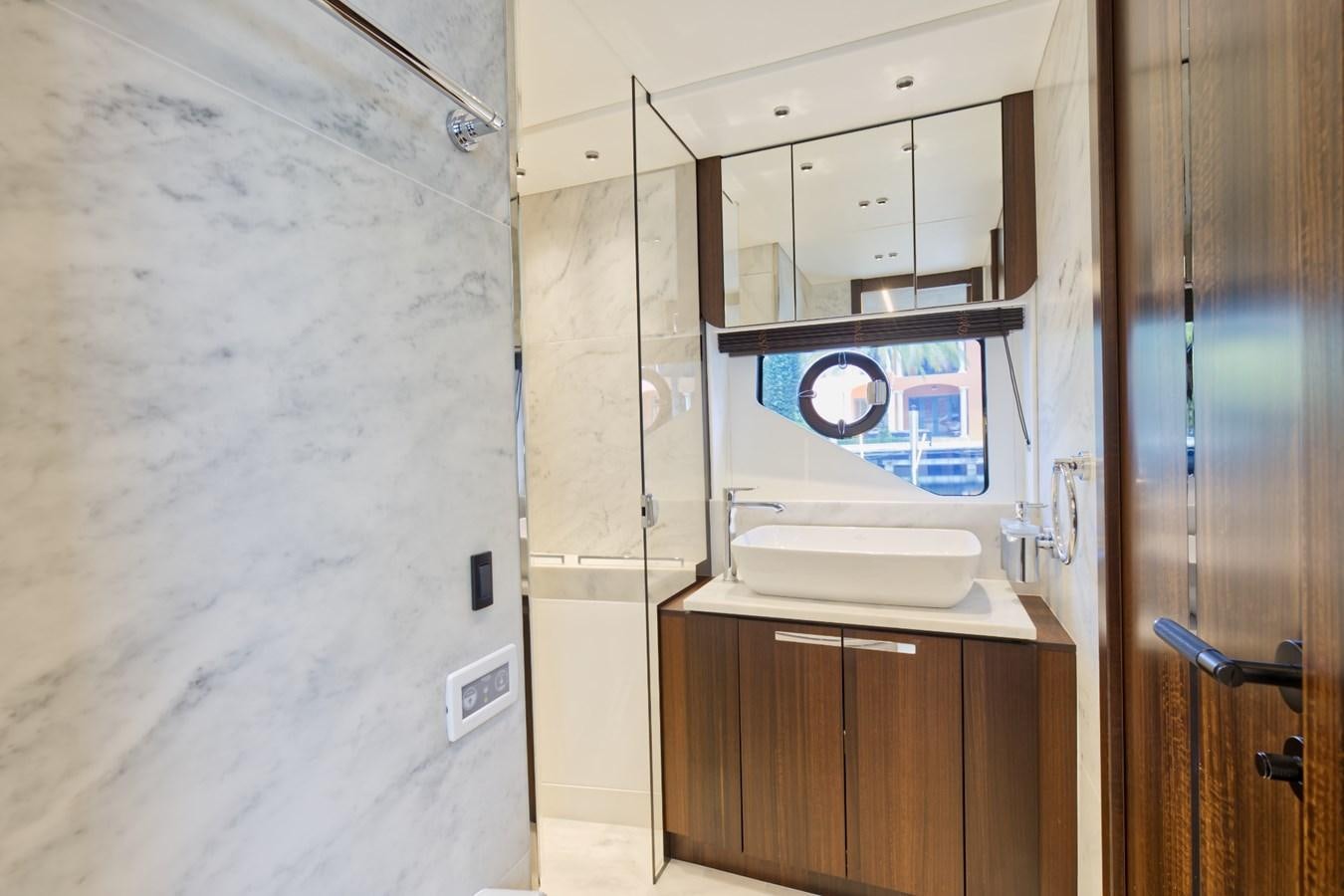 a bathroom with a sink and a sign on the wall aboard SUNSEEKER 75 SPORT YACHT Yacht for Sale