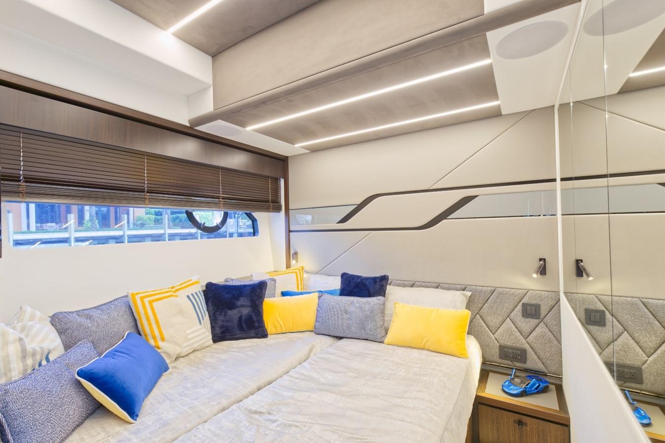 a bed with pillows and a window aboard SUNSEEKER 75 SPORT YACHT Yacht for Sale