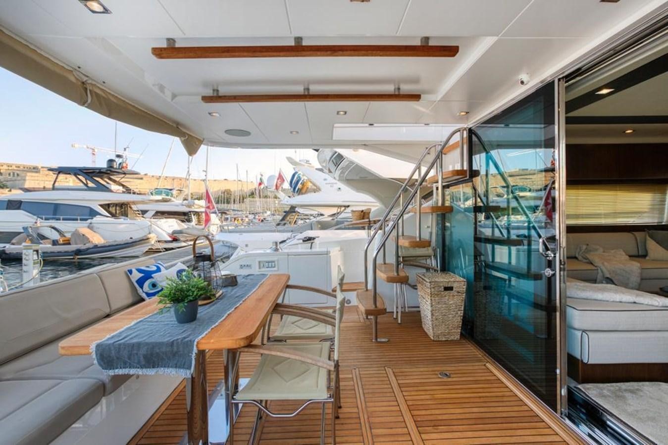 a boat with a table and chairs aboard LANA 1 Yacht for Sale