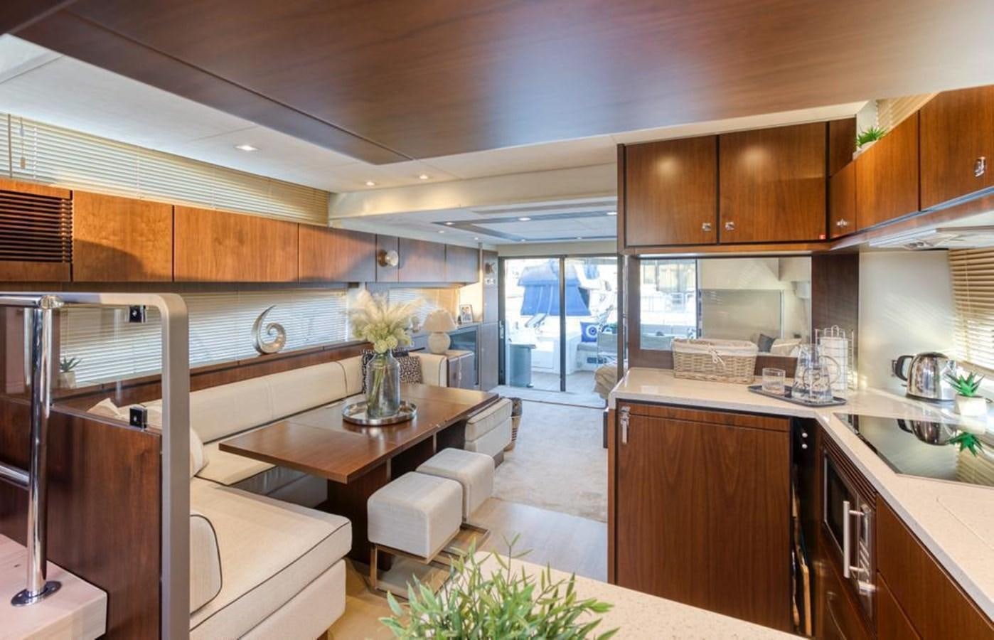 a kitchen with wooden cabinets aboard LANA 1 Yacht for Sale