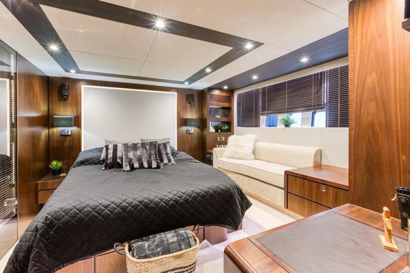 a bedroom with a bed and a table aboard LANA 1 Yacht for Sale