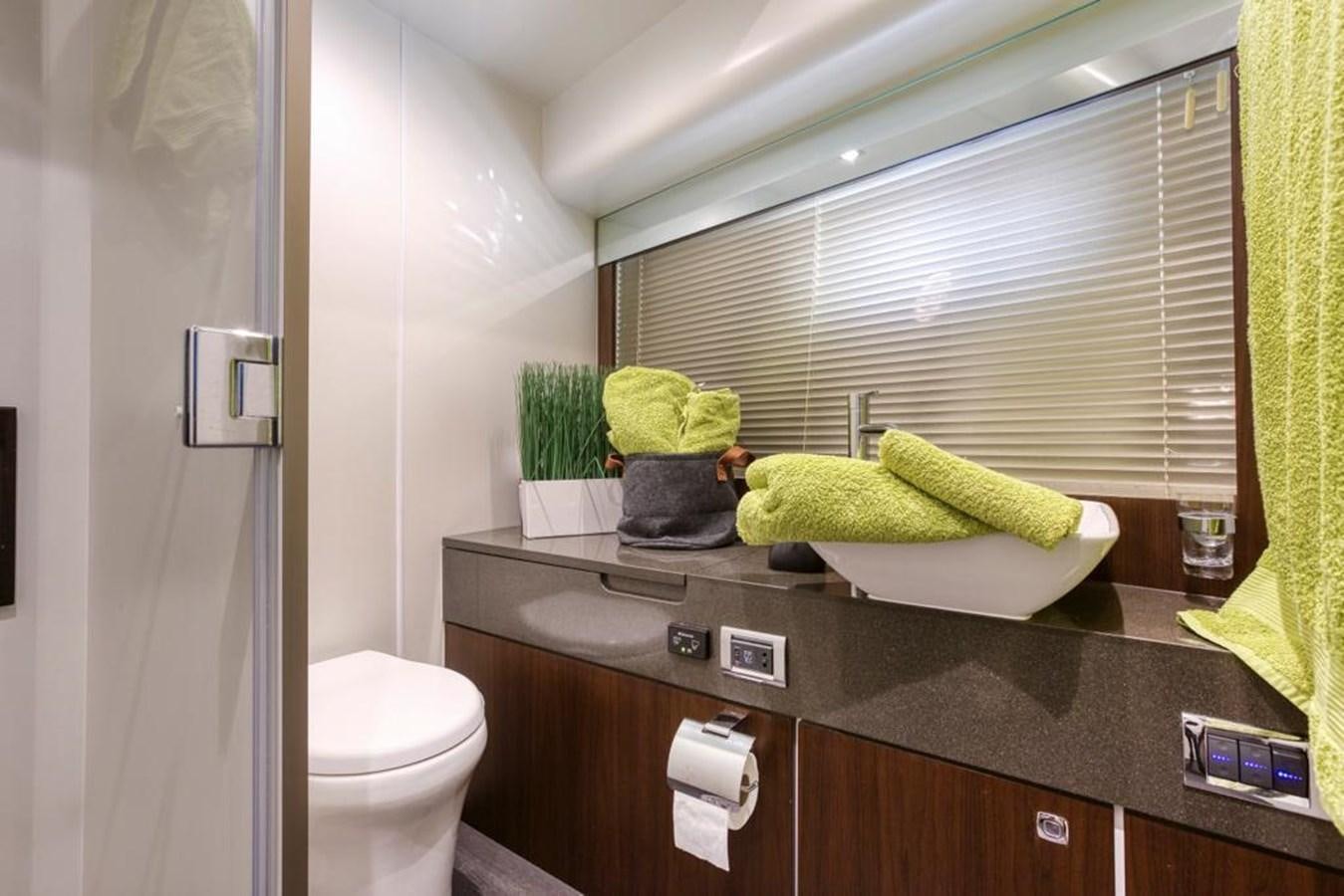 a bathroom with a countertop sink and towels aboard LANA 1 Yacht for Sale