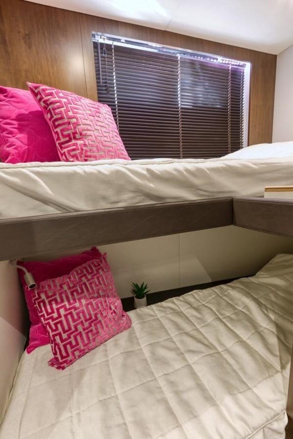 a bed with pillows and a window aboard LANA 1 Yacht for Sale