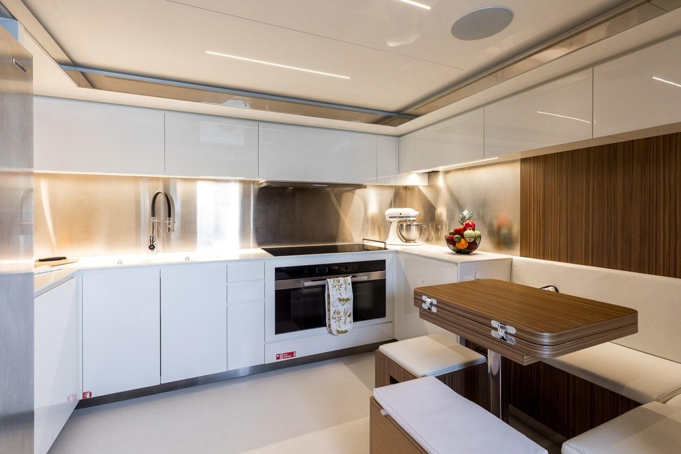 a kitchen with white cabinets aboard RIES Yacht for Sale