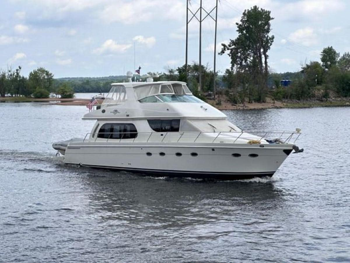 a white boat on the water aboard 2005 CARVER 56 VOYAGER Yacht for Sale