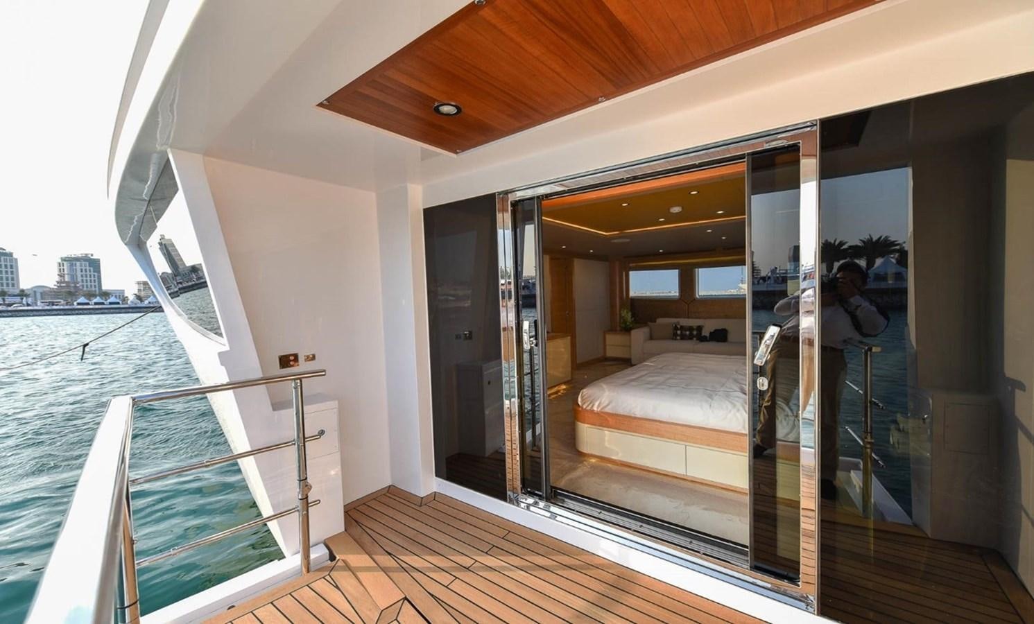 a room with a bed and a balcony aboard 'H Yacht for Sale