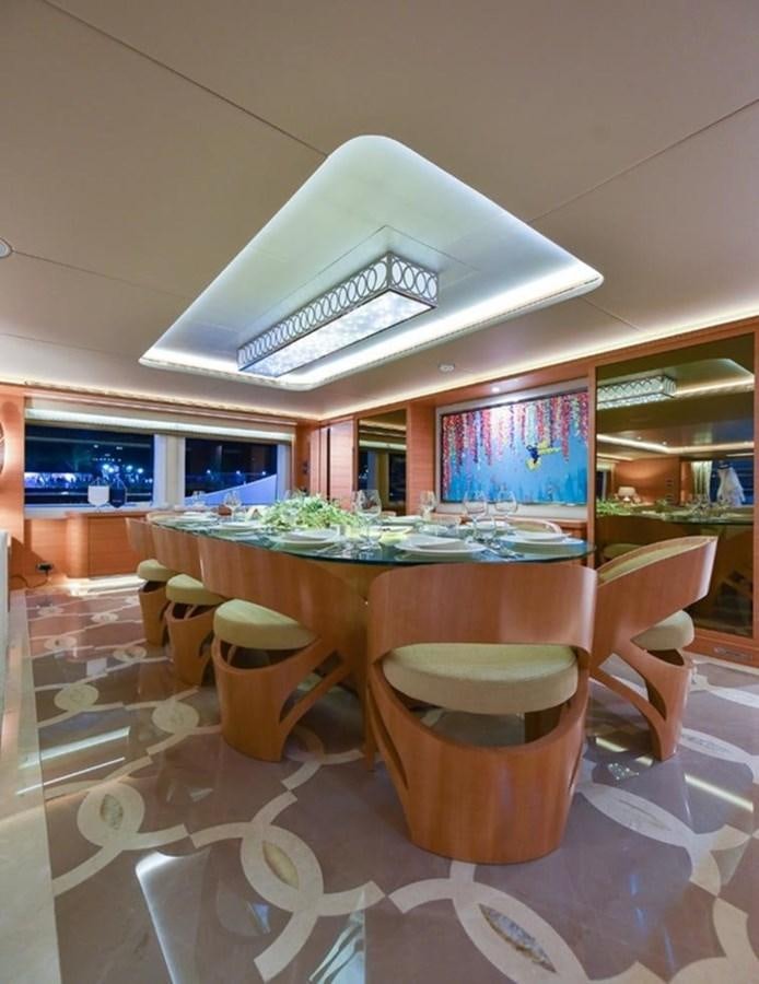 a table with a large white umbrella aboard 'H Yacht for Sale