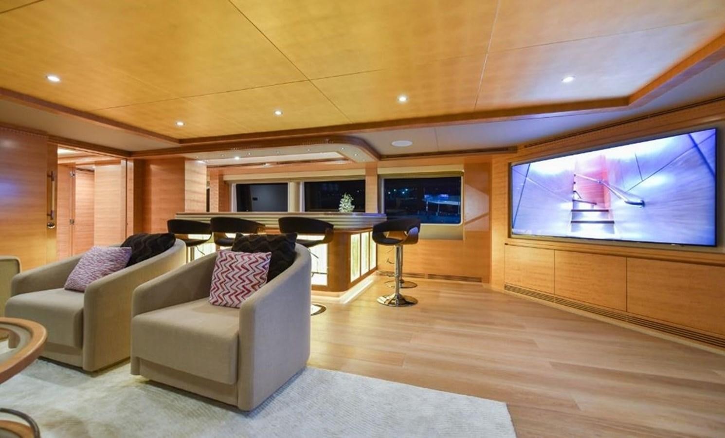 a living room with a large screen aboard 'H Yacht for Sale