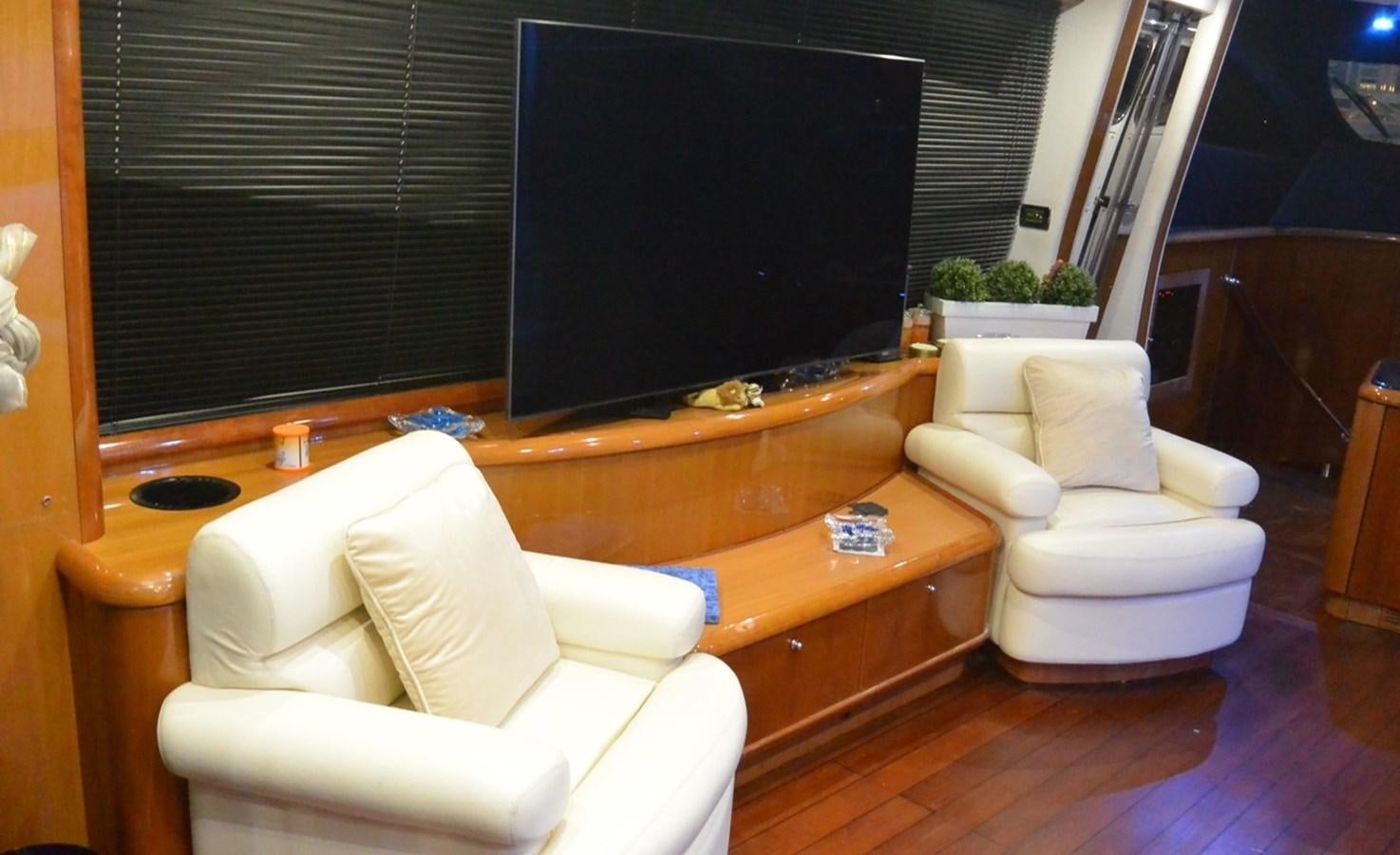 a room with a tv and couches aboard 2004 SUNSEEKER PREDATOR 95 Yacht for Sale