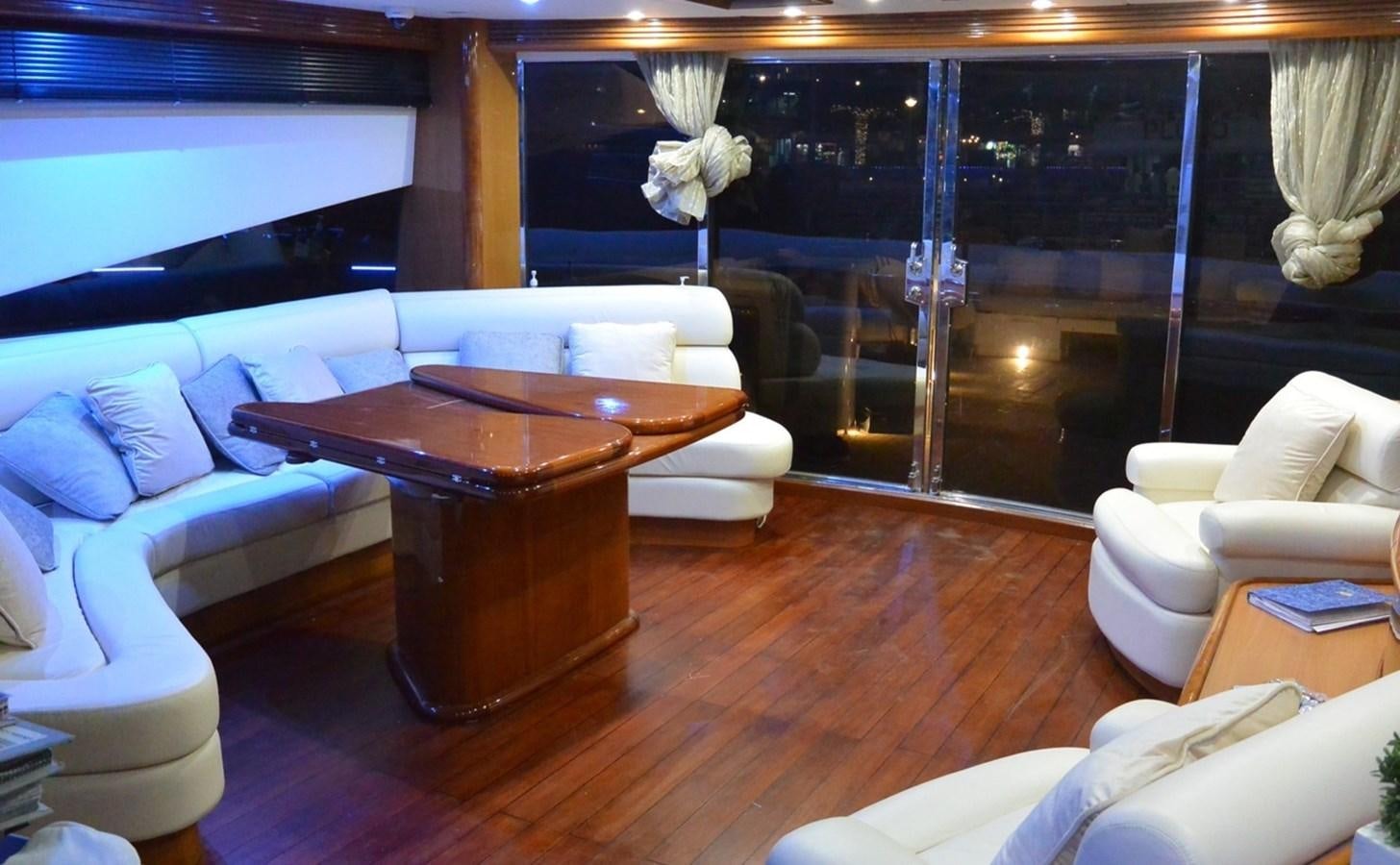 a living room with a table and chairs aboard 2004 SUNSEEKER PREDATOR 95 Yacht for Sale