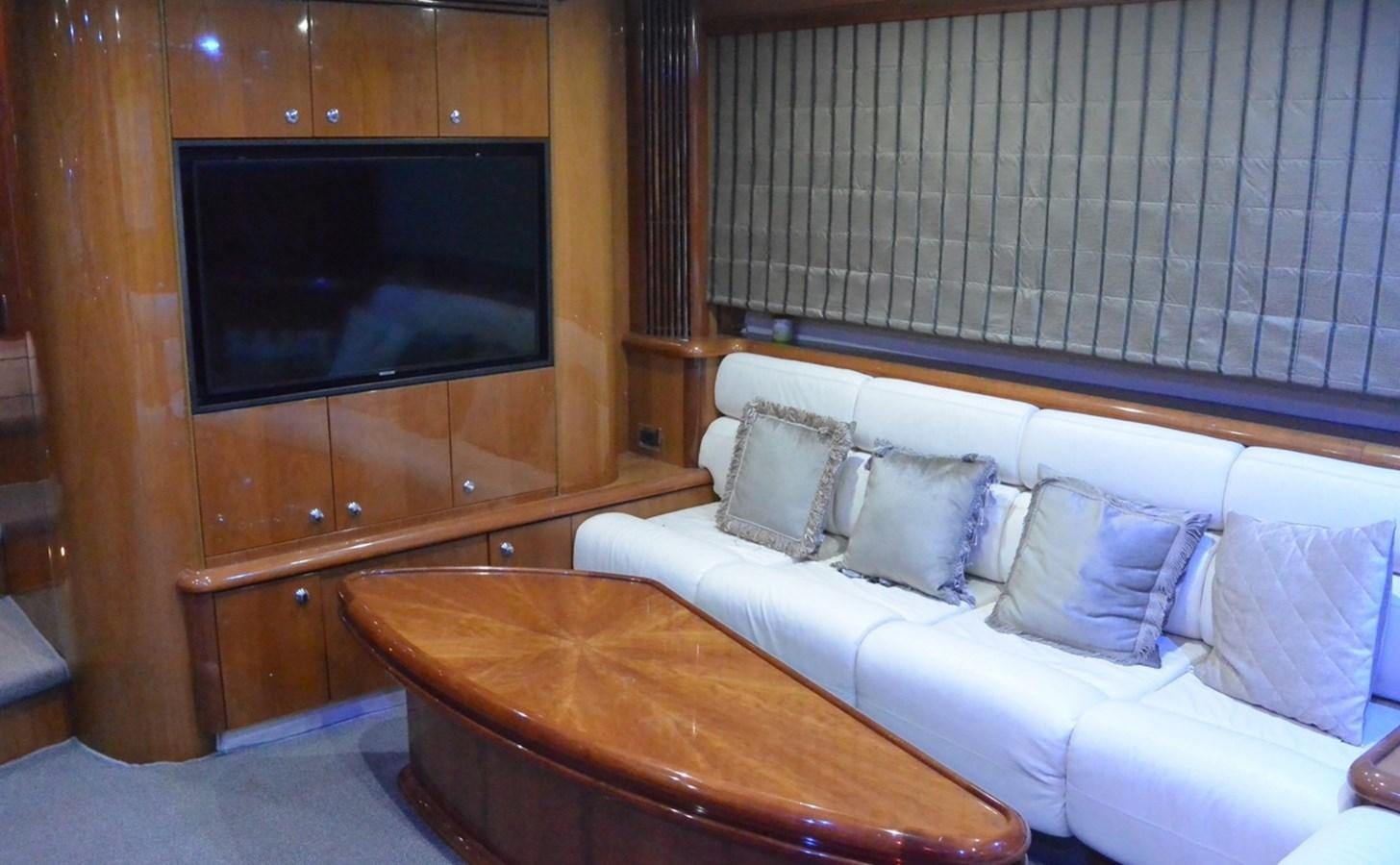 a living room with a couch and a television aboard 2004 SUNSEEKER PREDATOR 95 Yacht for Sale