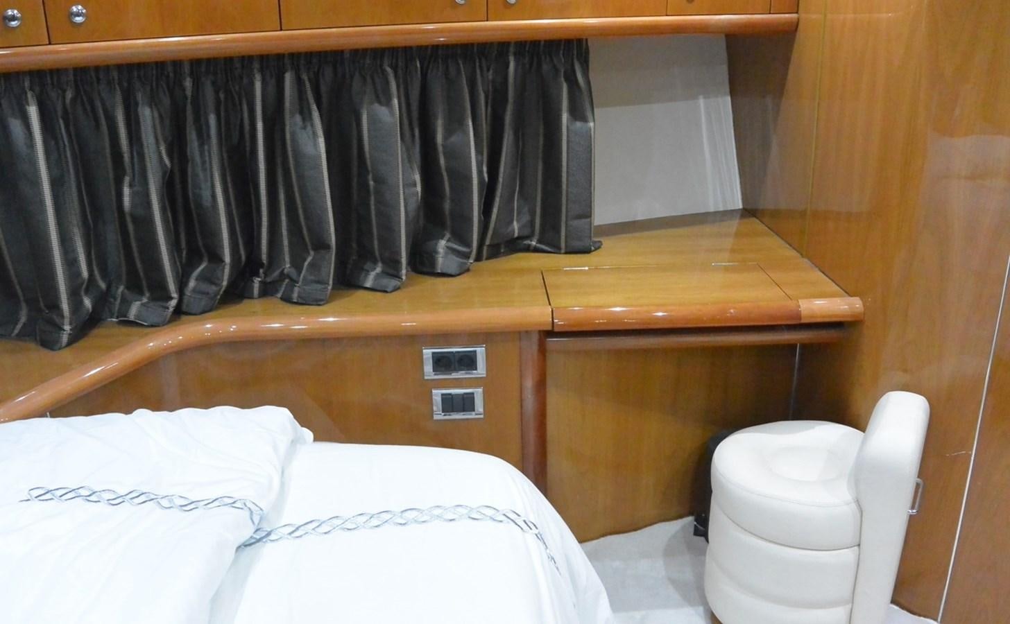 a closet with clothes on the wall aboard 2004 SUNSEEKER PREDATOR 95 Yacht for Sale