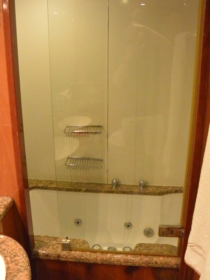 a glass cabinet with a glass door aboard 2004 SUNSEEKER PREDATOR 95 Yacht for Sale