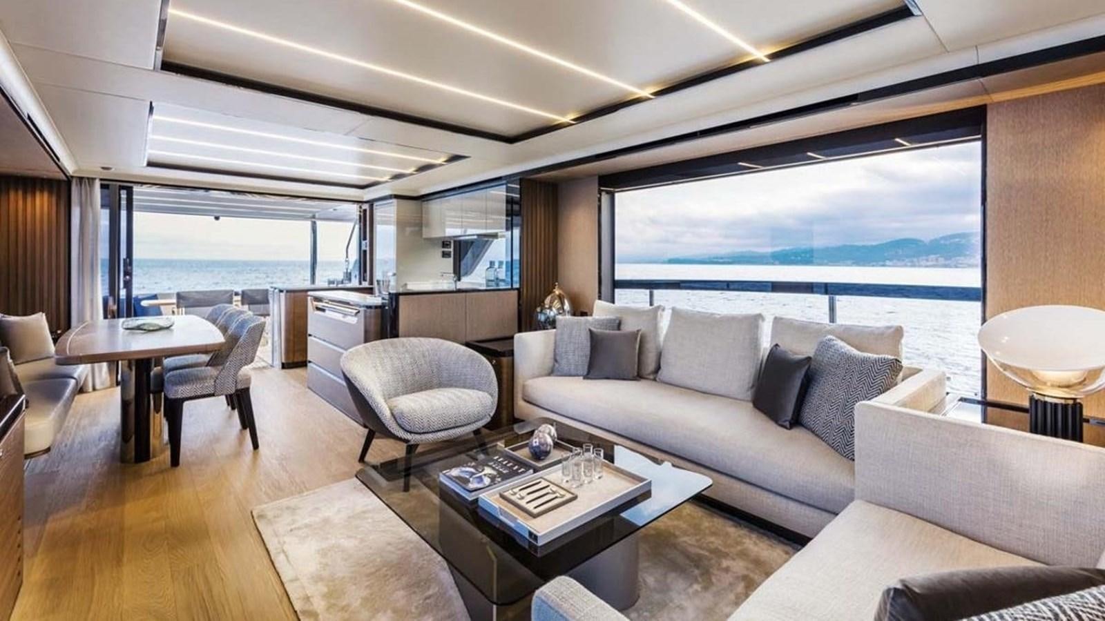 a living room with a large window aboard LEGEND II Yacht for Sale