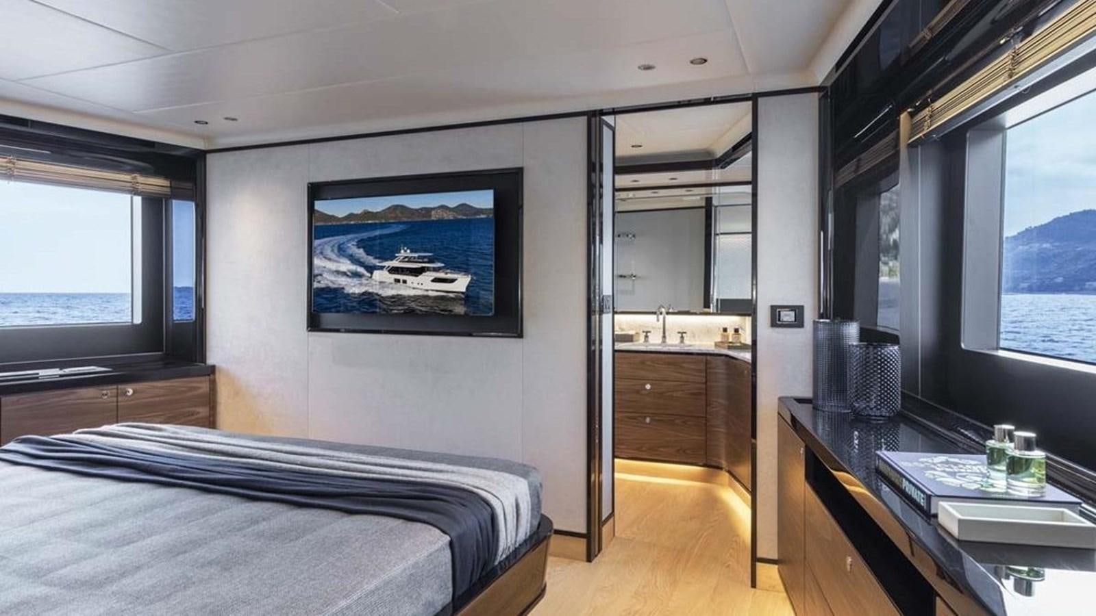 a room with a bed and a desk aboard LEGEND II Yacht for Sale