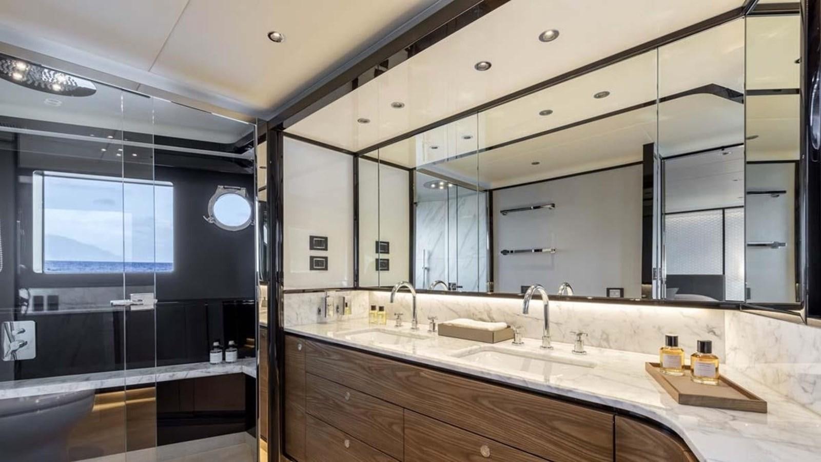 a bathroom with a large mirror aboard LEGEND II Yacht for Sale