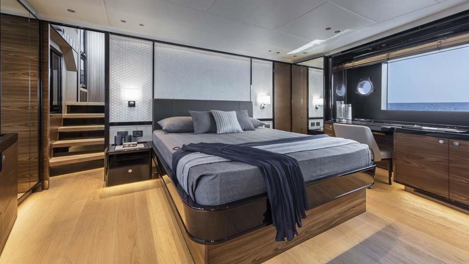 a large bedroom with a large bed aboard LEGEND II Yacht for Sale