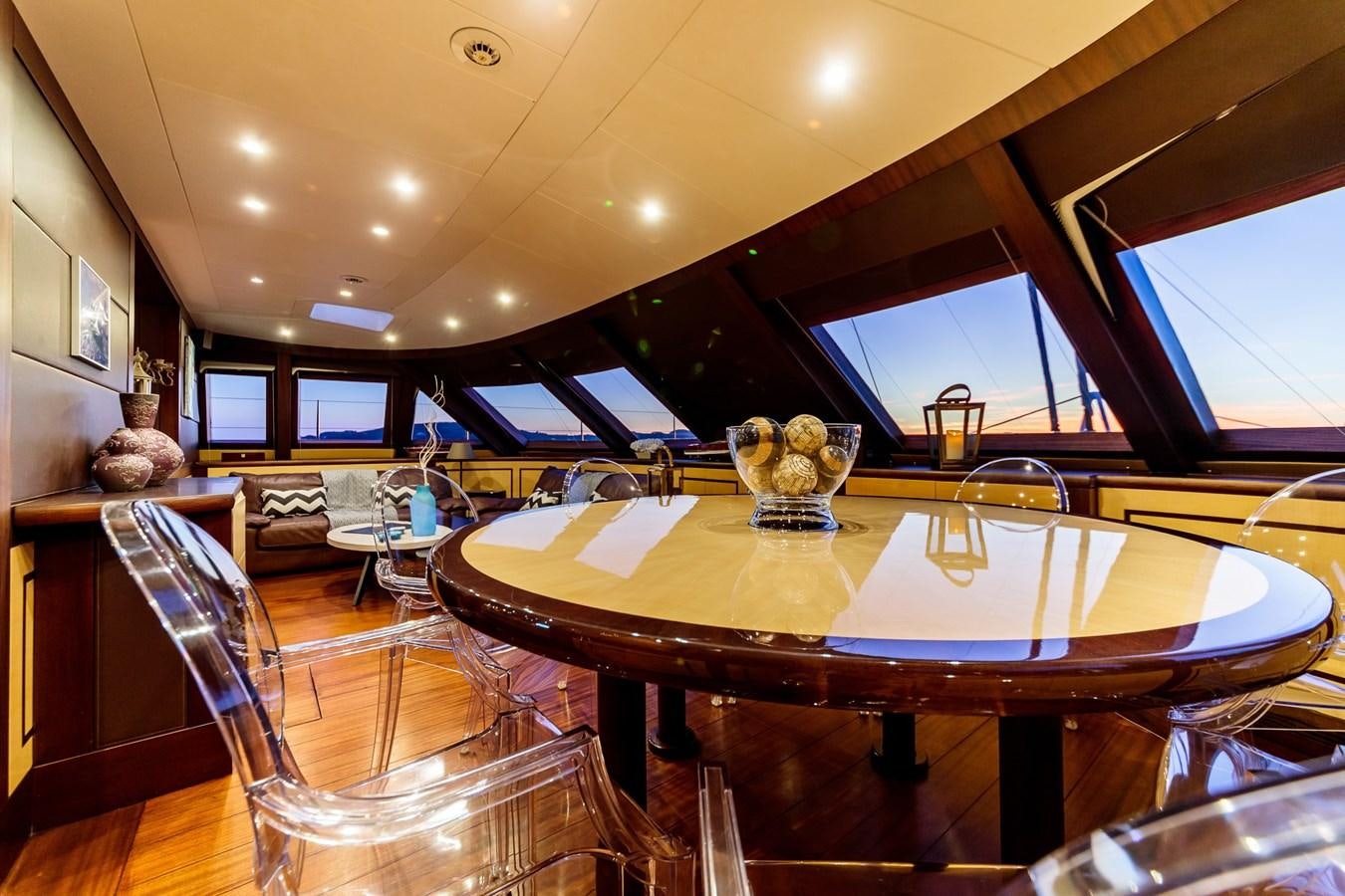 a large dining table in a room aboard ALLURES Yacht for Sale