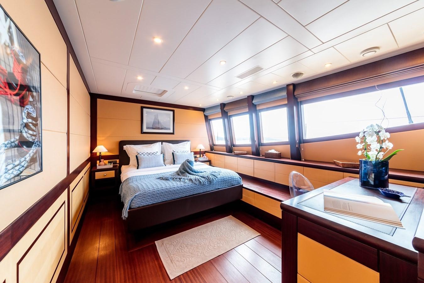 a room with a bed and a desk aboard ALLURES Yacht for Sale