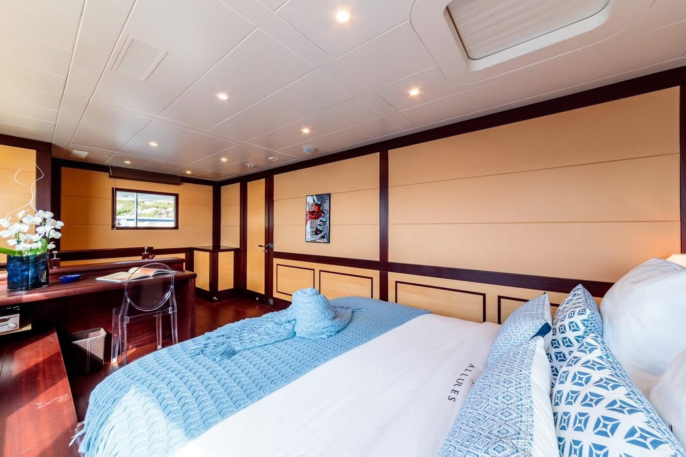 a bed in a room aboard ALLURES Yacht for Sale