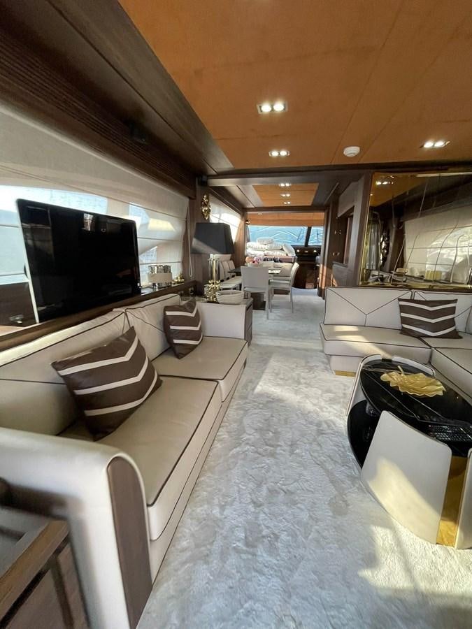a living room with a large television aboard AOP Yacht for Sale