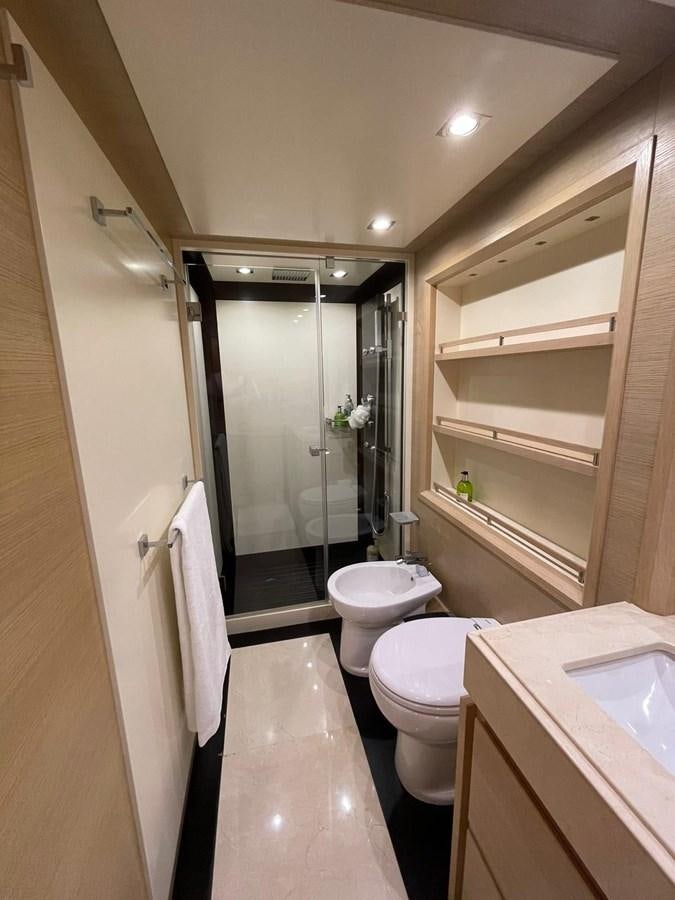 a bathroom with a glass shower door aboard AOP Yacht for Sale