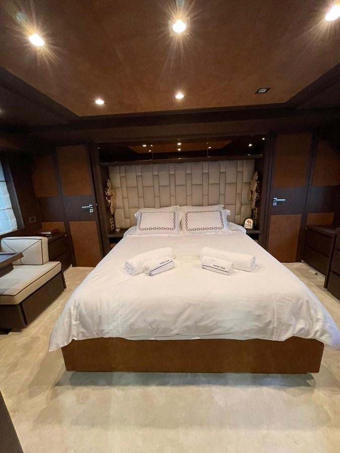 a bed with white sheets aboard AOP Yacht for Sale