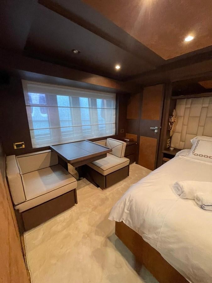 a hotel room with a bed and a table aboard AOP Yacht for Sale
