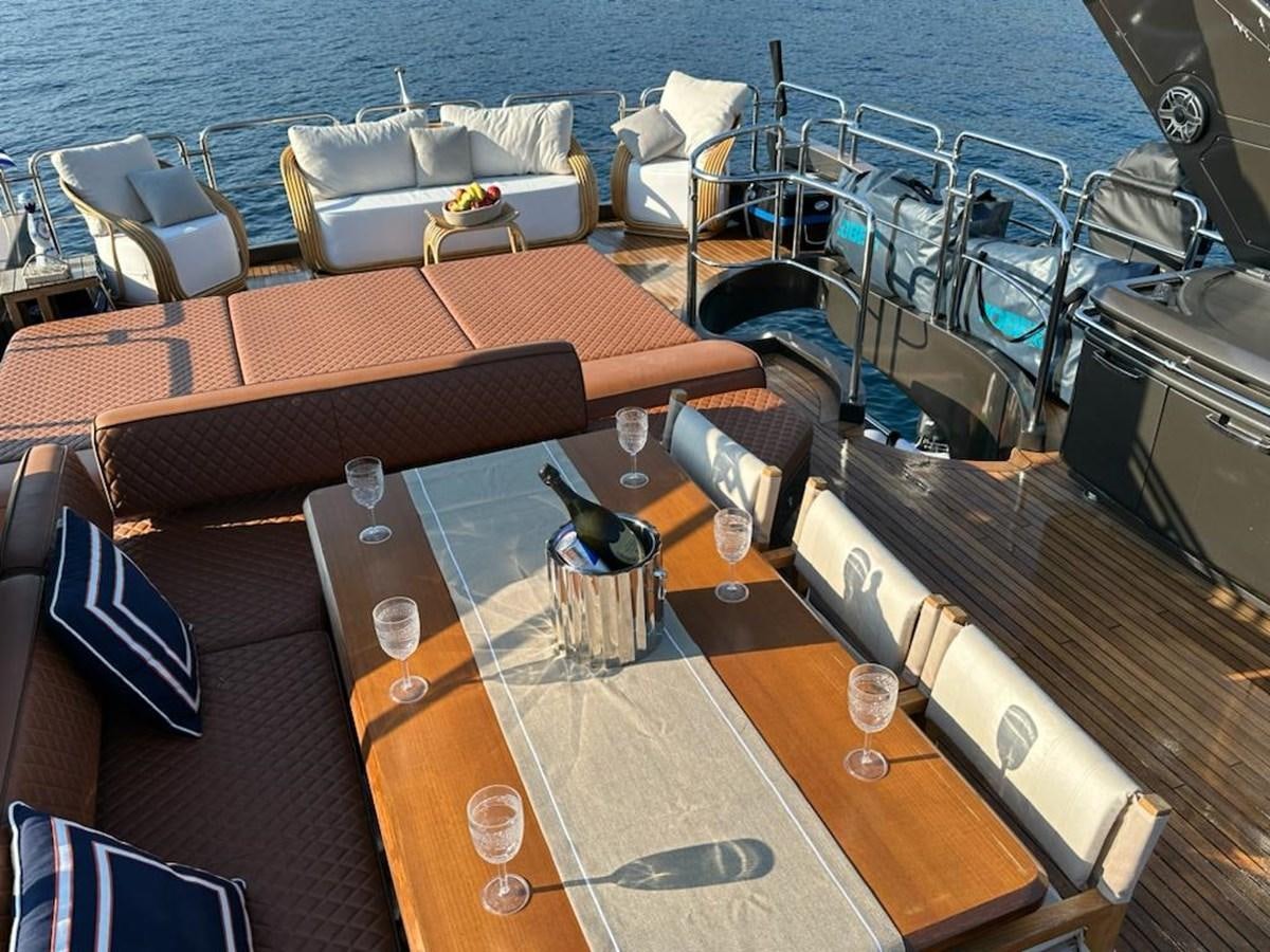a boat with a table and chairs aboard AOP Yacht for Sale