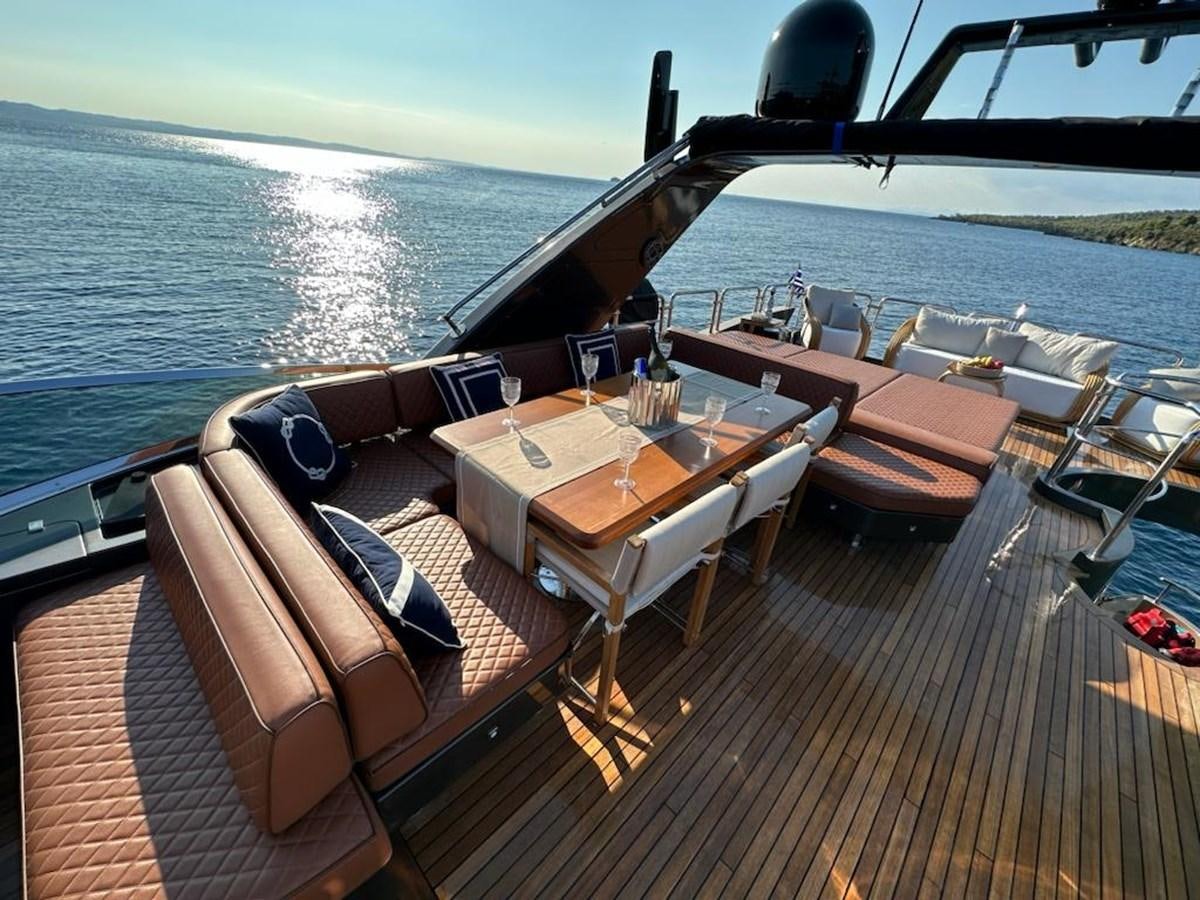 a deck with a view of the ocean and a boat aboard AOP Yacht for Sale
