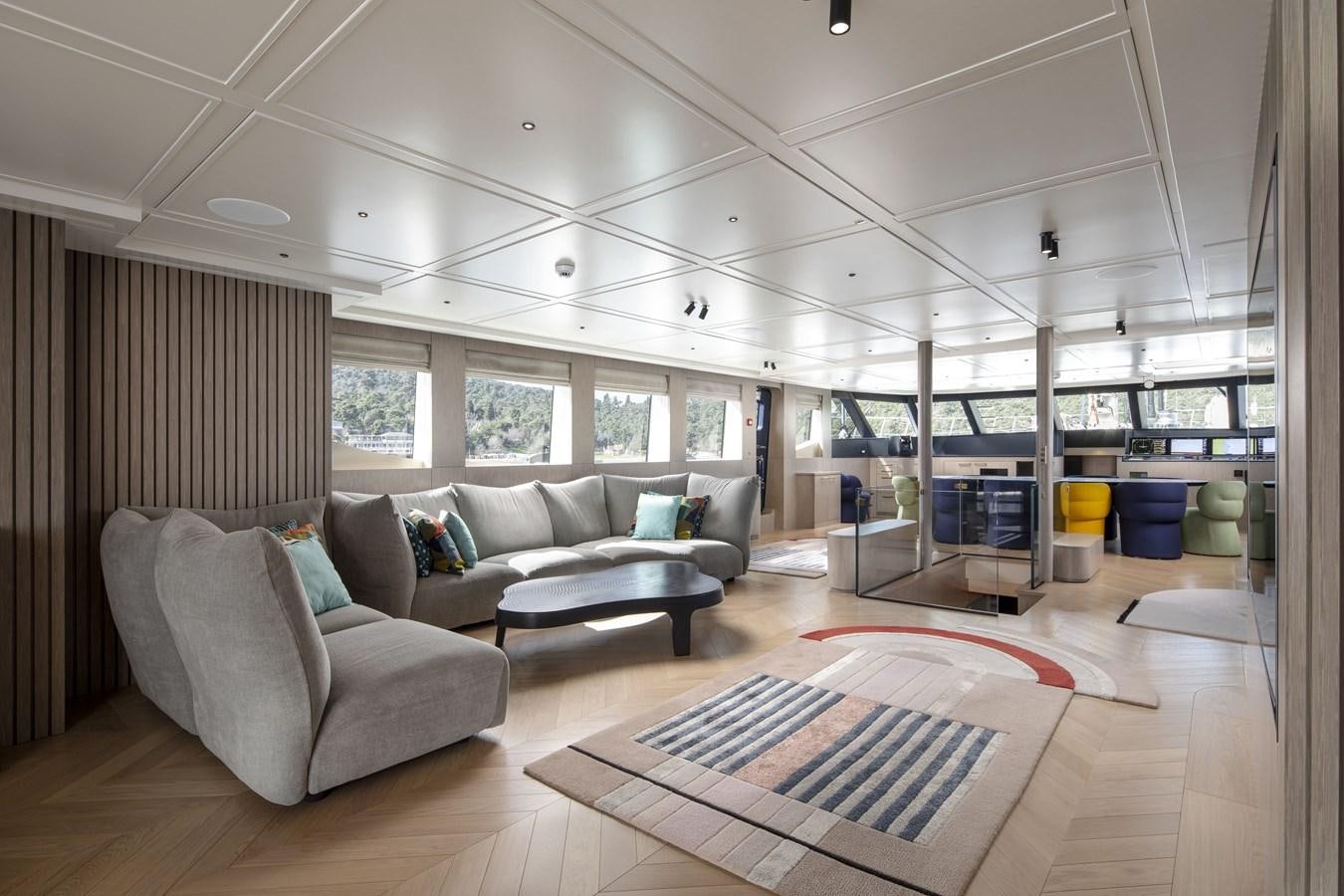 a room with a couch and a table aboard L'AQUILA Yacht for Sale