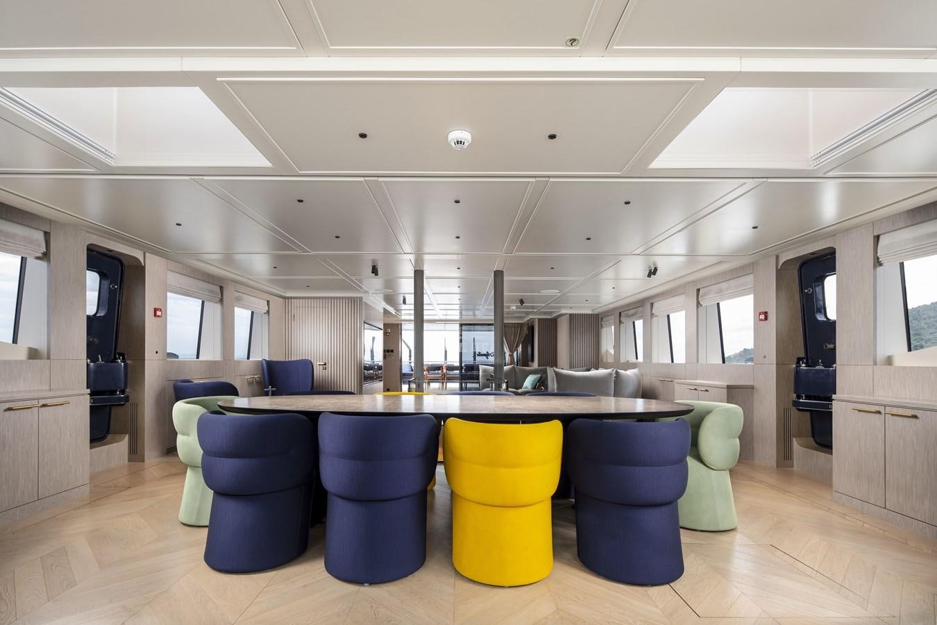 a large room with chairs and tables aboard L'AQUILA Yacht for Sale