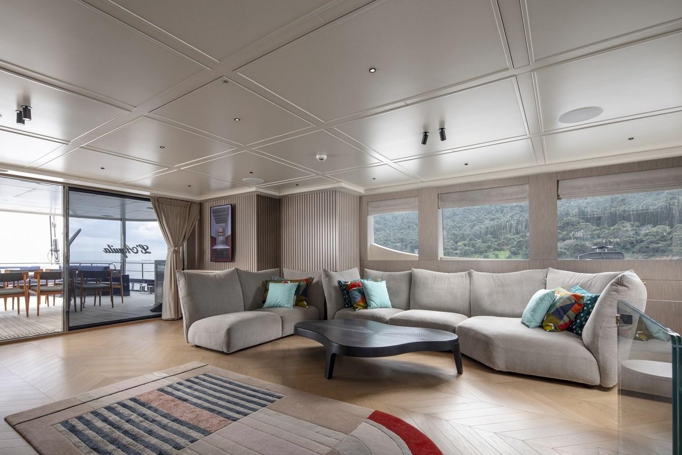 a living room with a couch and a table aboard L'AQUILA Yacht for Sale
