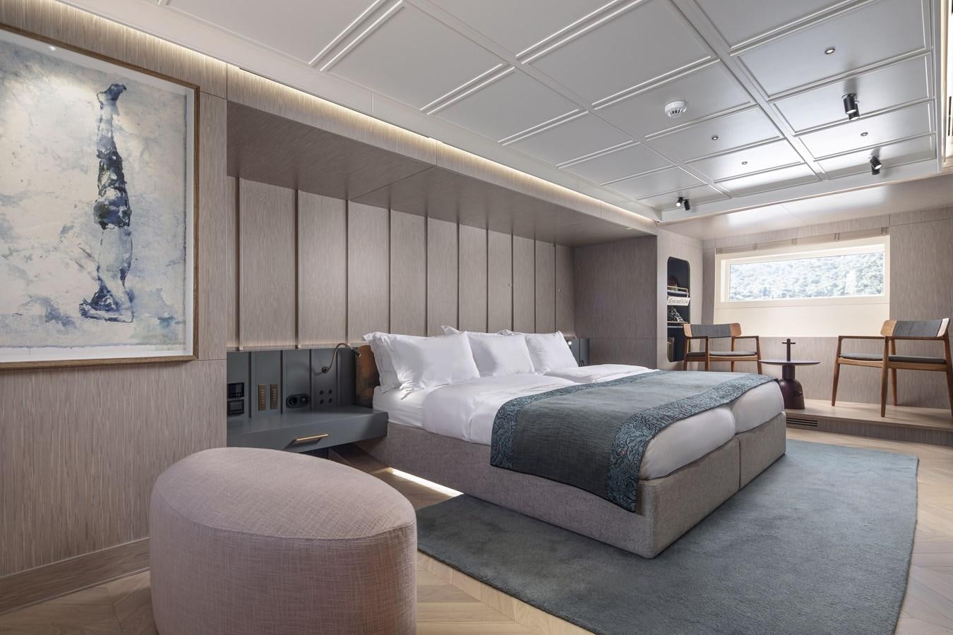 a room with a bed and a table aboard L'AQUILA Yacht for Sale