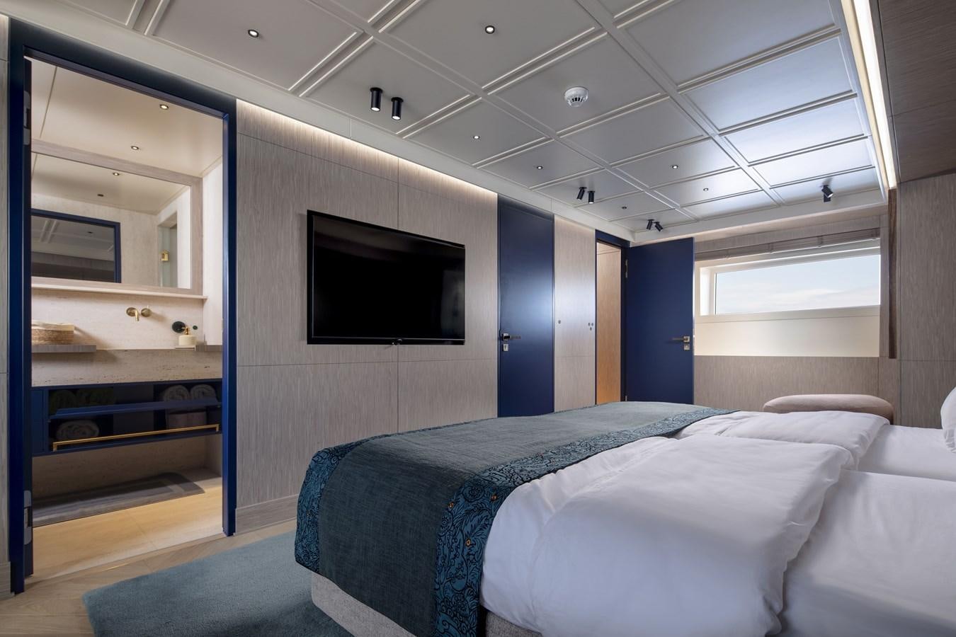 a bedroom with a bed and a tv aboard L'AQUILA Yacht for Sale