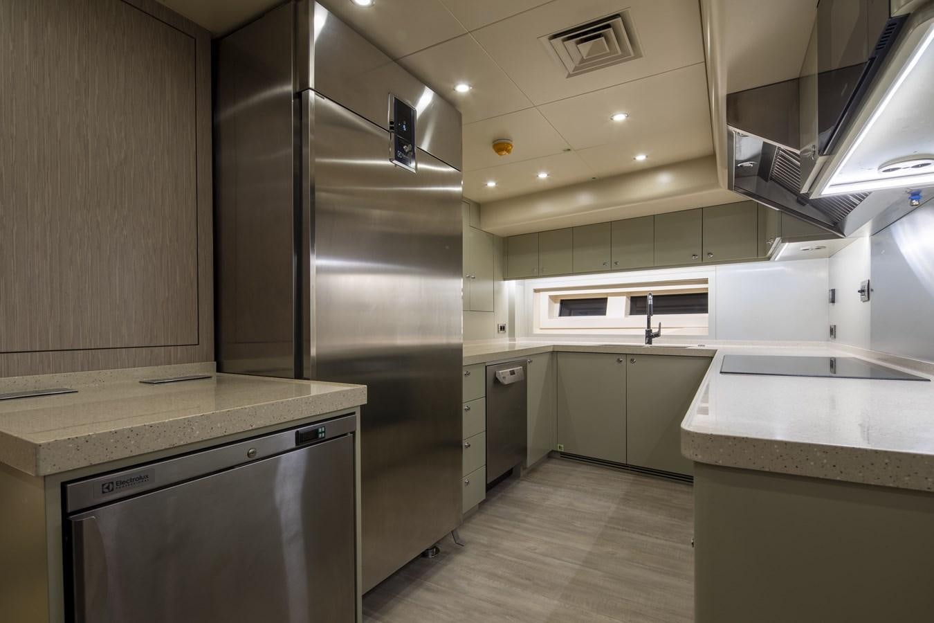 a kitchen with a stainless steel refrigerator aboard L'AQUILA Yacht for Sale
