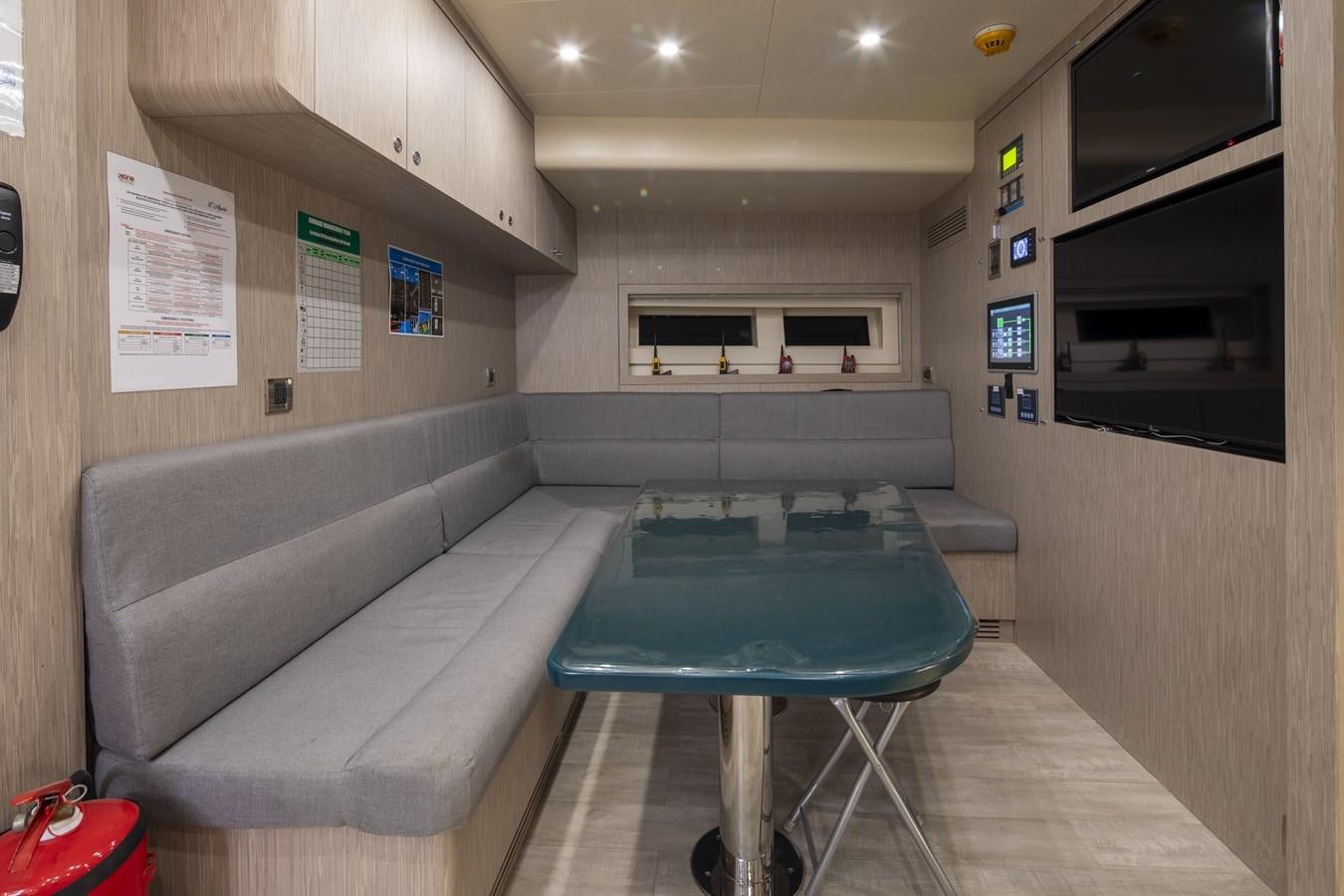 a room with a table and a couch aboard L'AQUILA Yacht for Sale