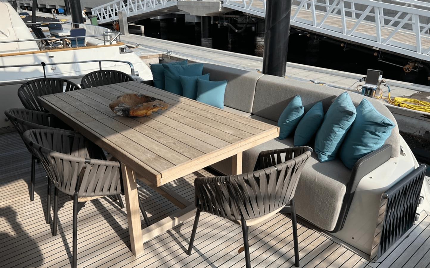 a table with chairs around it aboard 2022 CRANCHI 78 Yacht for Sale