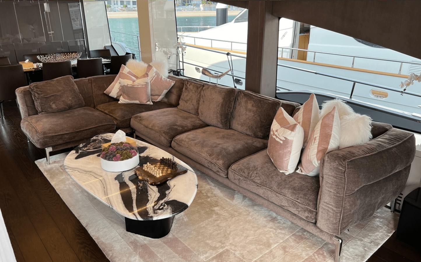 a couch and a coffee table aboard 2022 CRANCHI 78 Yacht for Sale