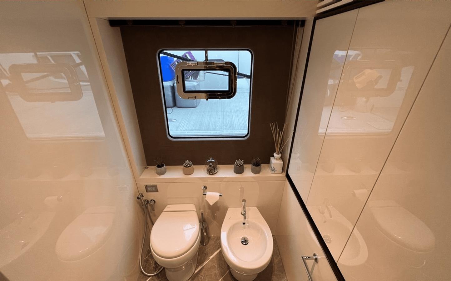 a bathroom with a mirror and a bathtub aboard 2022 CRANCHI 78 Yacht for Sale