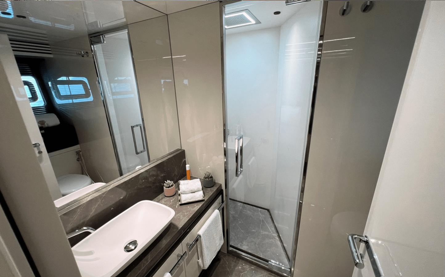 a bathroom with a countertop sink and mirror aboard 2022 CRANCHI 78 Yacht for Sale