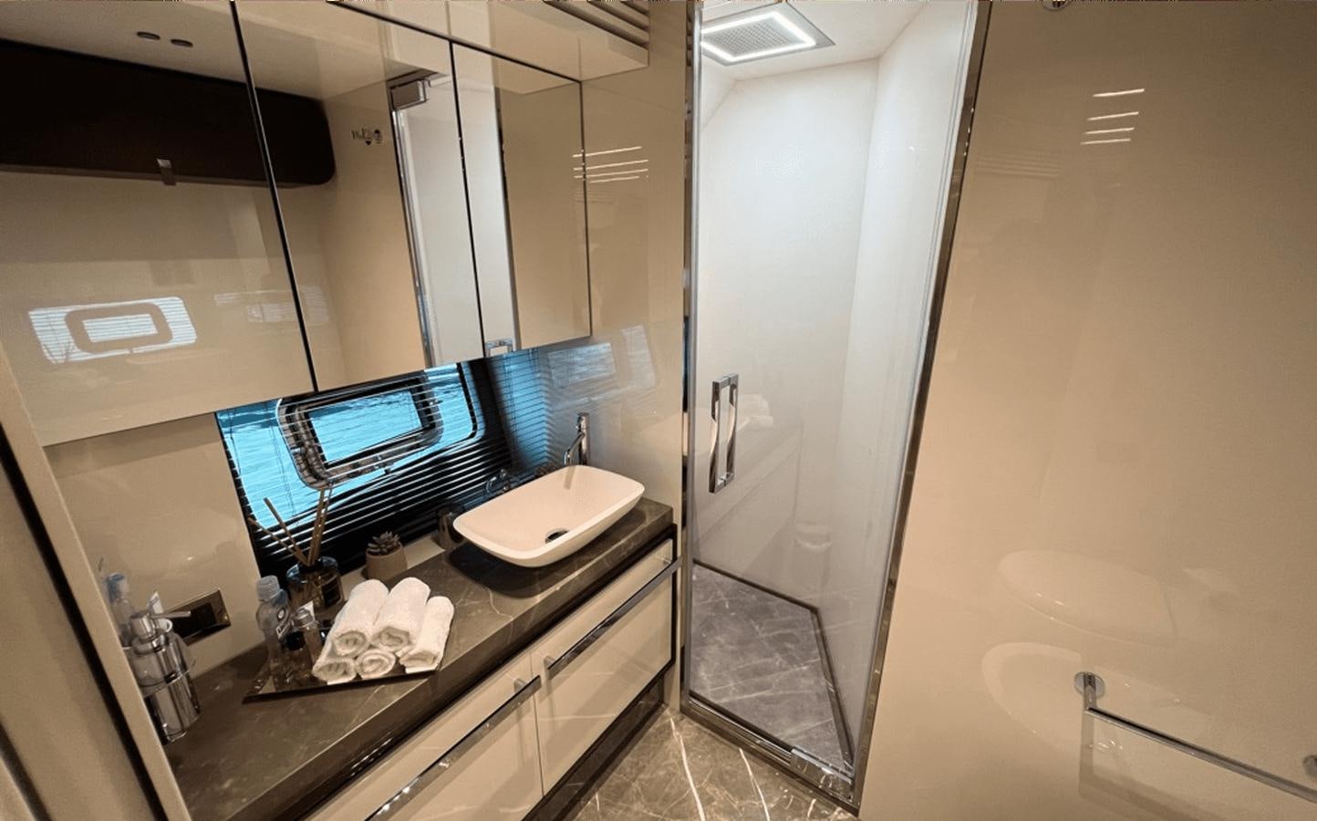 a bathroom with a tv and a sink aboard 2022 CRANCHI 78 Yacht for Sale