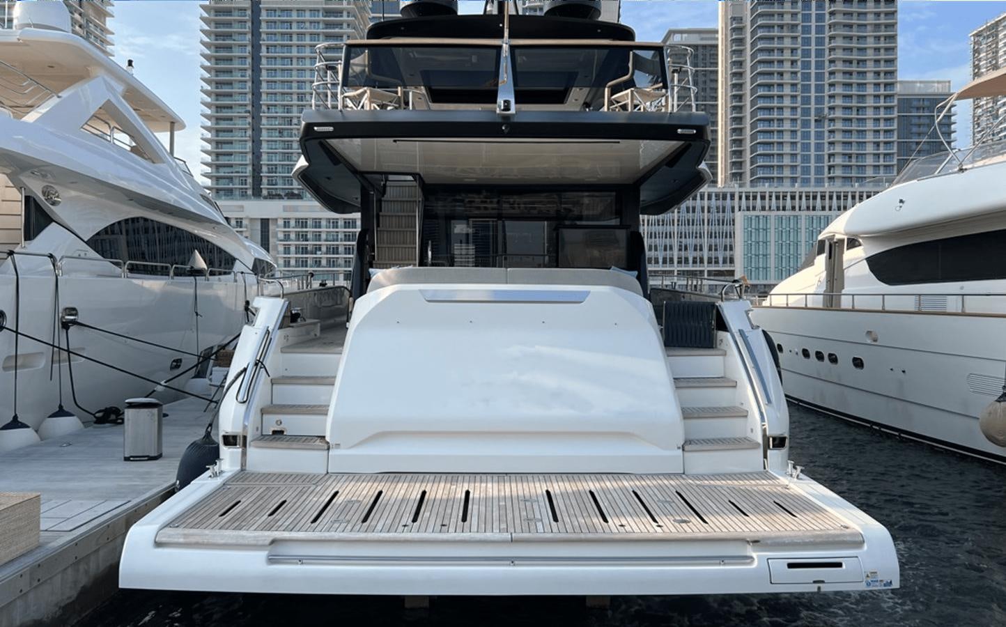 a white boat on a dock aboard 2022 CRANCHI 78 Yacht for Sale