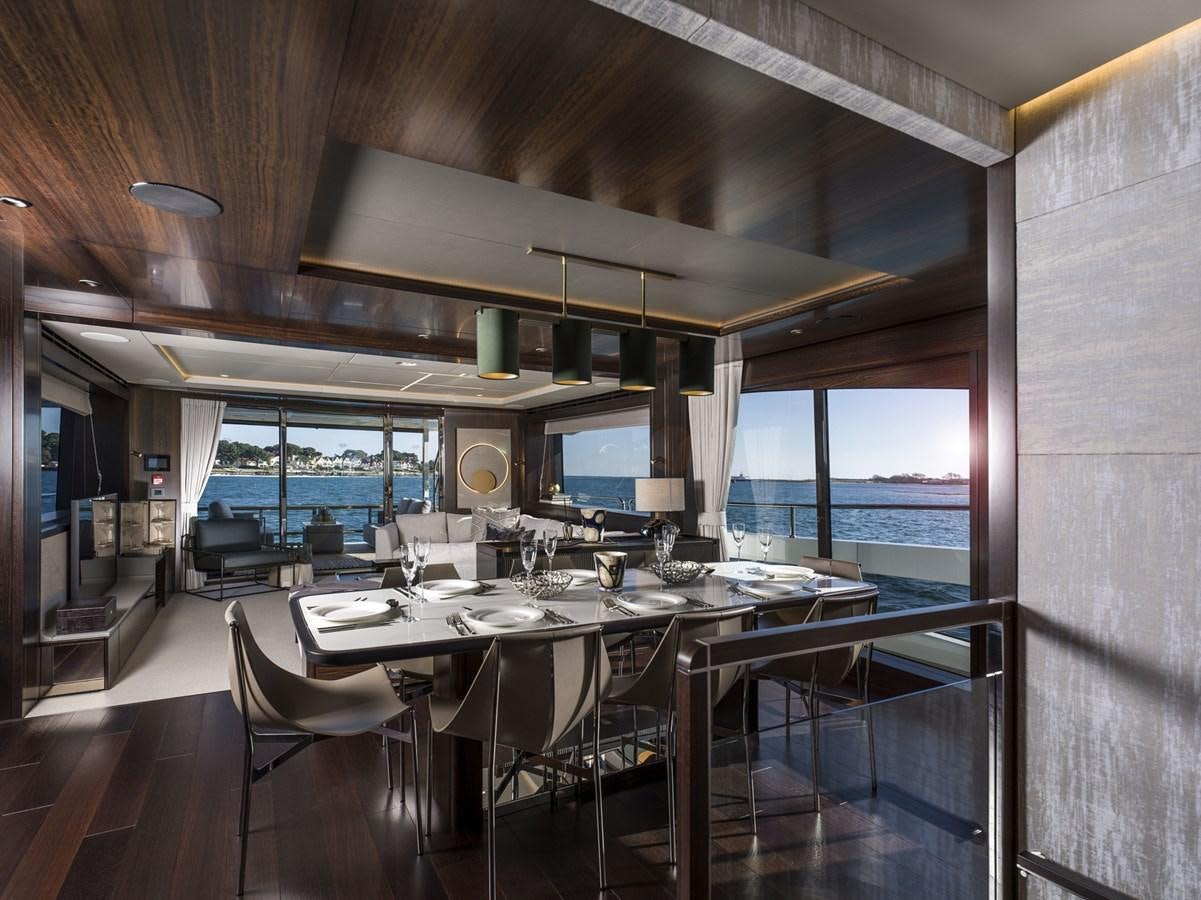 a large dining table in a room aboard JUNIOR Yacht for Sale